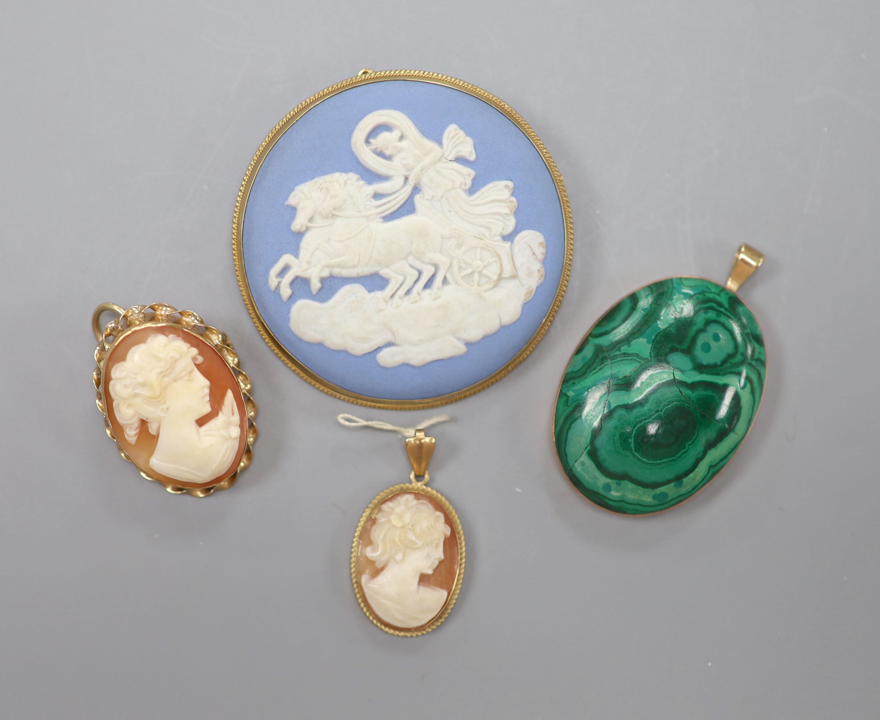 A modern 9ct gold mounted Wedgwood brooch, 49mm, a similar cameo brooch, a 9ct and cameo pendant and yellow metal and malachite pendant(a.f.)
